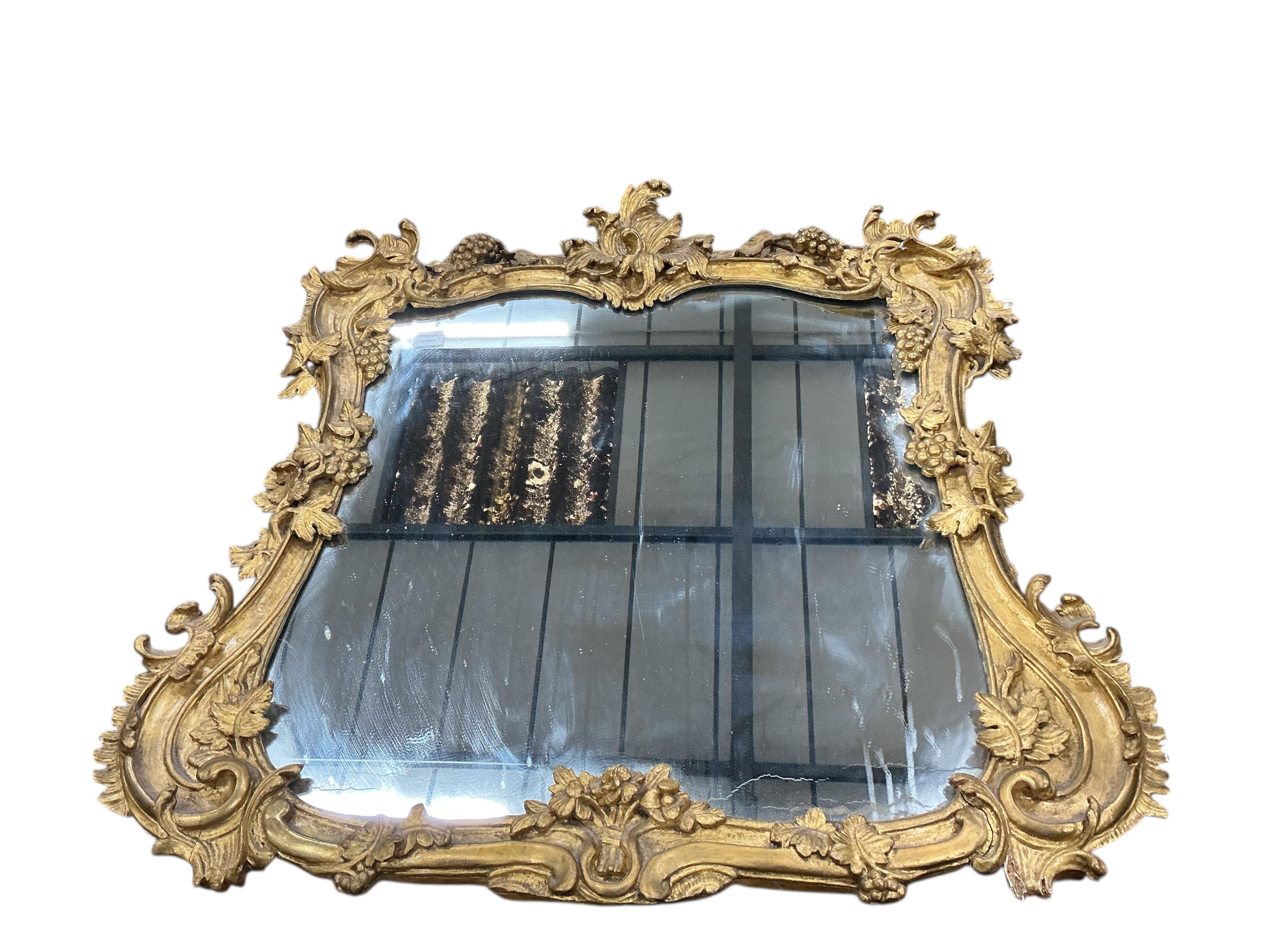 A Victorian carved giltwood and composition wall mirror with fruiting vine borders, width 98cm, height 104cm
